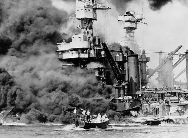 Survivors are rescued from the waters of Pearl Harbor as USS West Virginia burns in the background. (US Navy)